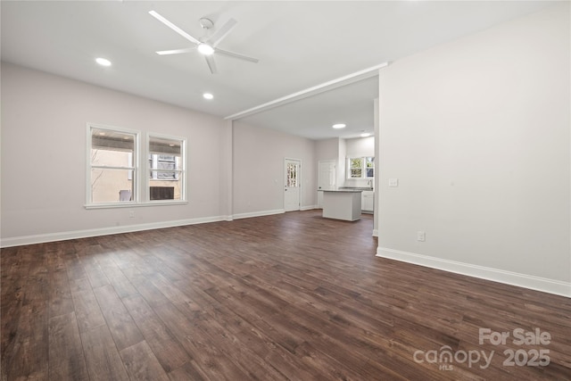 unfurnished living room featuring recessed lighting, baseboards, dark wood-type flooring, and a ceiling fan