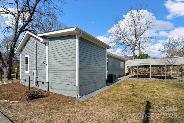 view of home's exterior featuring crawl space, central air condition unit, a yard, and a carport