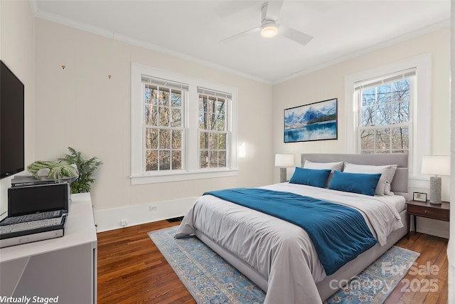 bedroom featuring crown molding, baseboards, and wood finished floors