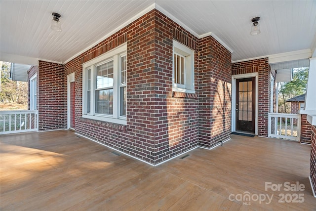 wooden terrace with a porch and visible vents