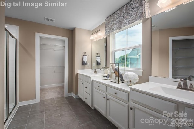 1240 Cottage Green Dr Unit 0132, Monroe, NC 28112 - bathroom with a walk in closet, double vanity, a stall shower, and baseboards