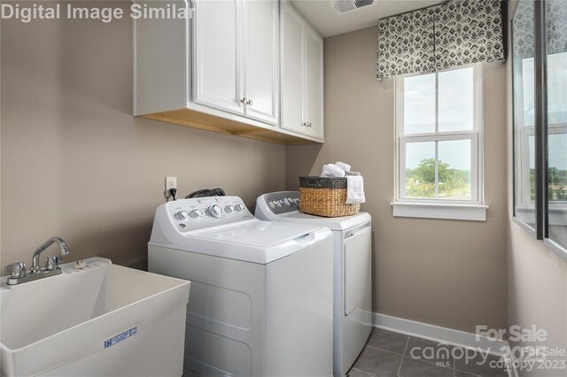 1240 Cottage Green Dr Unit 0132, Monroe, NC 28112 - washroom featuring cabinet space, washer and clothes dryer, dark tile patterned floors, and baseboards