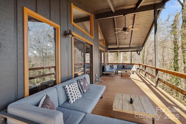 sunroom / solarium featuring a ceiling fan, wood ceiling, and vaulted ceiling with beams