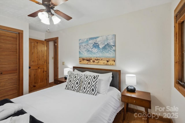 bedroom featuring a closet, wood finished floors, and a ceiling fan