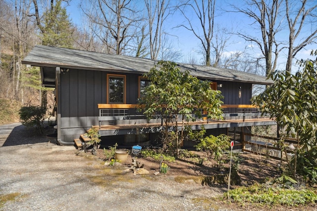 exterior space with board and batten siding and a wooden deck