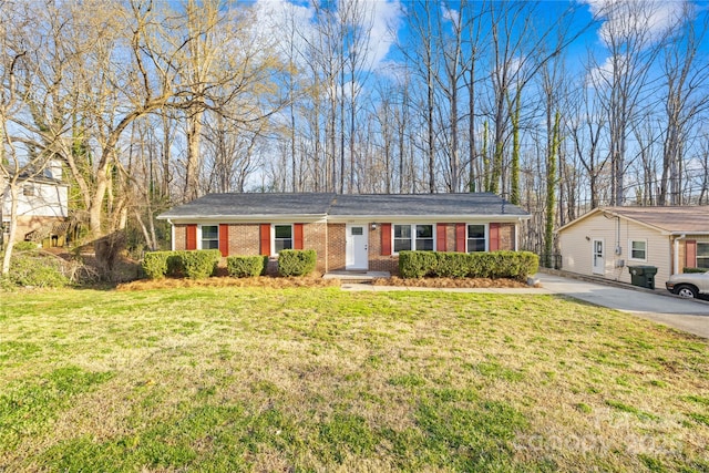 ranch-style home featuring brick siding, concrete driveway, and a front lawn