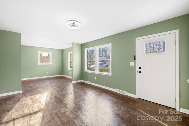 entryway featuring visible vents, a healthy amount of sunlight, baseboards, and wood finished floors