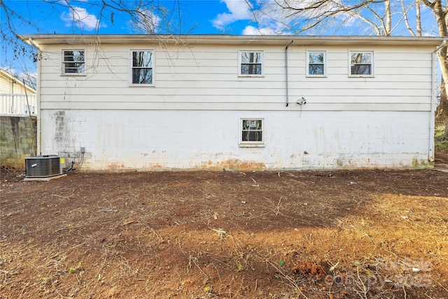 back of property featuring central AC