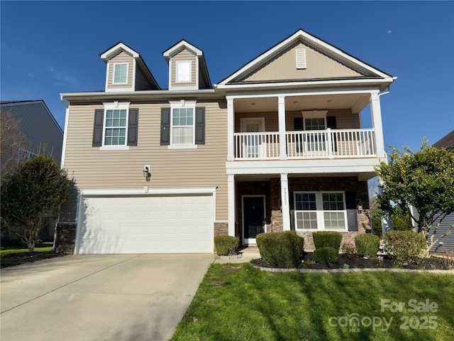 view of front of home featuring a balcony, an attached garage, and driveway