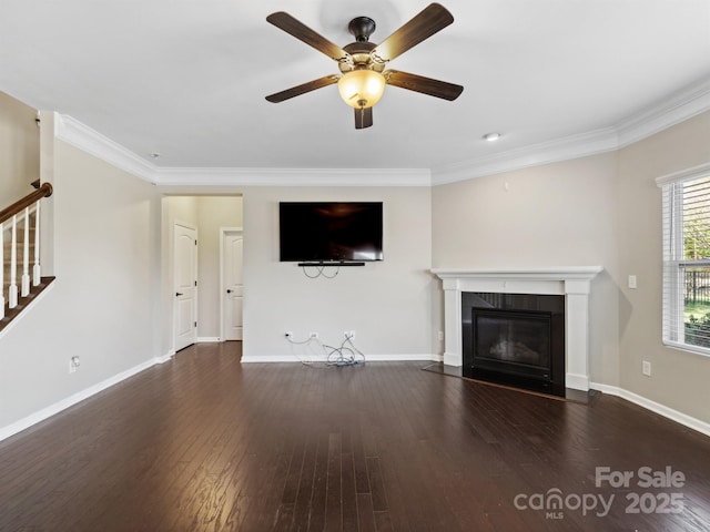 unfurnished living room with stairs, wood finished floors, and ornamental molding