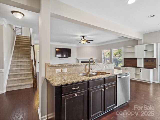 kitchen featuring light stone counters, a sink, dark wood-type flooring, and stainless steel dishwasher