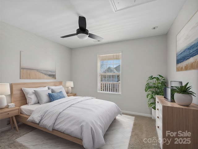 bedroom featuring a ceiling fan, visible vents, baseboards, attic access, and light carpet