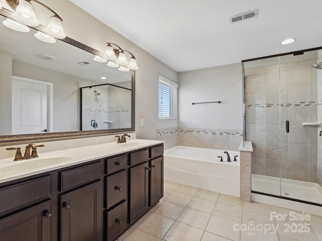 full bathroom featuring tile patterned flooring, visible vents, a shower stall, a garden tub, and a sink