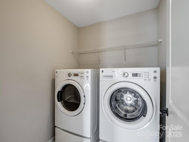 laundry room with laundry area and washing machine and clothes dryer