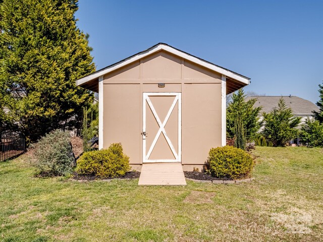 view of shed featuring fence