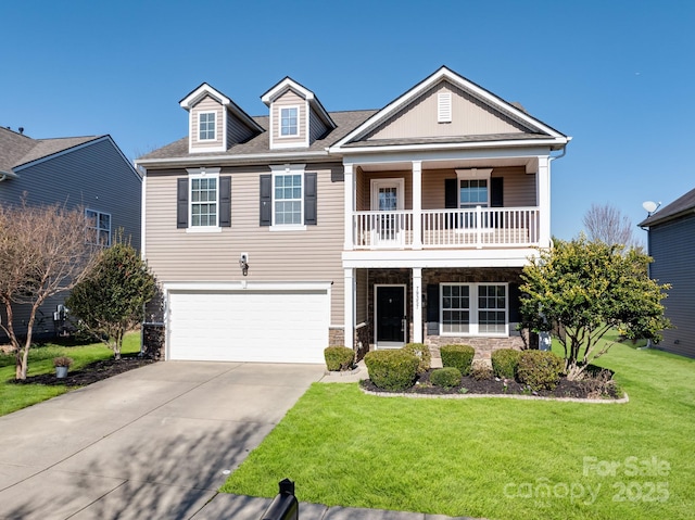 view of front of property with a front yard, a balcony, driveway, a garage, and stone siding