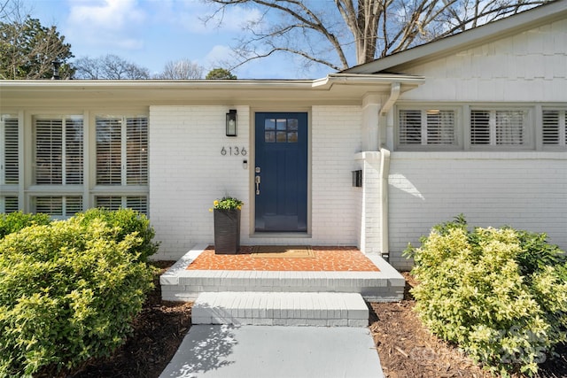 doorway to property with brick siding