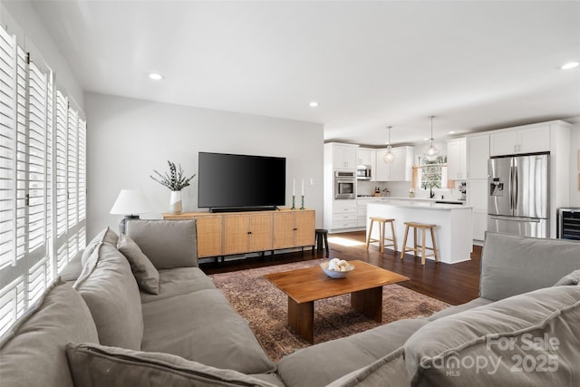 living room featuring dark wood finished floors and recessed lighting