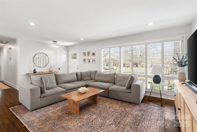 living room with wood finished floors, recessed lighting, and baseboards