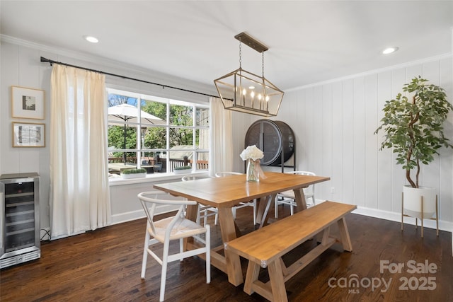 dining room featuring beverage cooler, ornamental molding, dark wood-style floors, recessed lighting, and baseboards