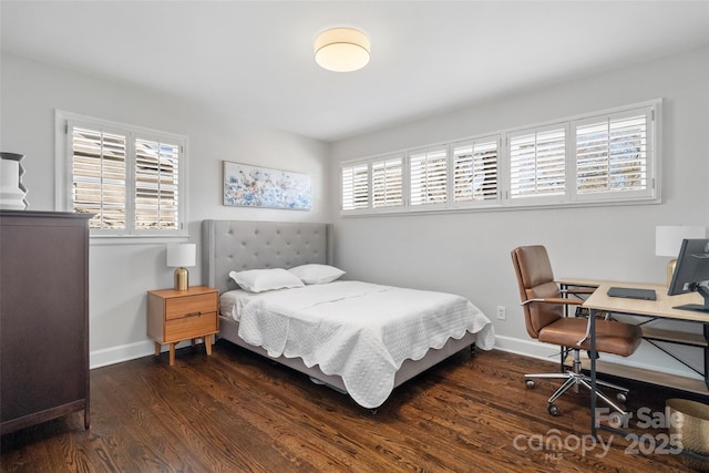 bedroom featuring baseboards and dark wood-style flooring