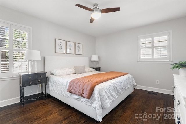 bedroom featuring visible vents, baseboards, dark wood-style floors, and a ceiling fan