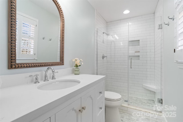 full bathroom with recessed lighting, toilet, a stall shower, and vanity