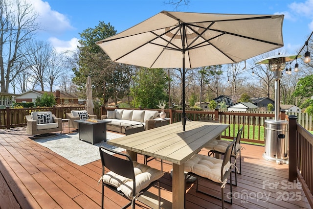 deck with outdoor dining space, an outdoor living space with a fire pit, and fence