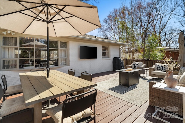 wooden deck featuring an outdoor living space with a fire pit, area for grilling, and outdoor dining area