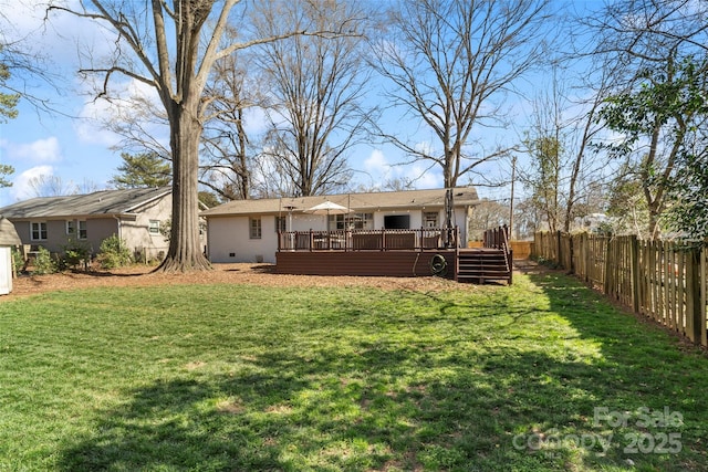 rear view of property featuring crawl space, a fenced backyard, a yard, and a deck