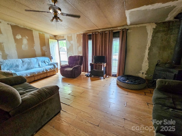living area featuring hardwood / wood-style floors and a ceiling fan