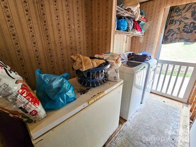 laundry room with washer and clothes dryer and laundry area