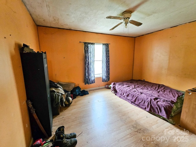 bedroom featuring wood finished floors and ceiling fan