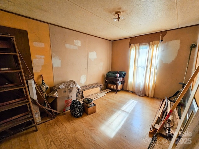 misc room with a textured ceiling and wood finished floors