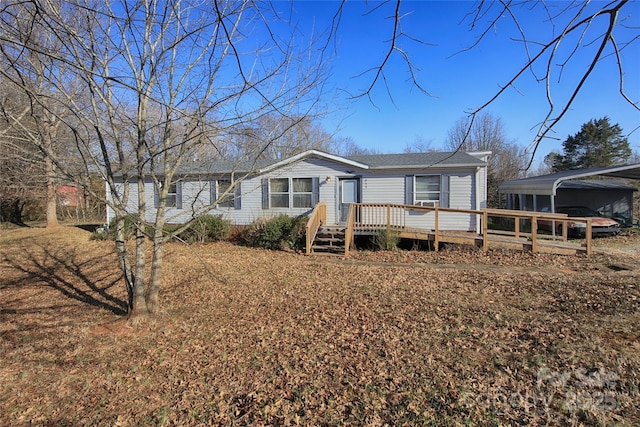 view of front of home with a carport and a deck