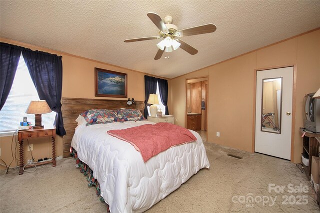 bedroom with visible vents, carpet floors, ornamental molding, vaulted ceiling, and a textured ceiling