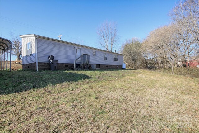 back of house featuring cooling unit and a yard