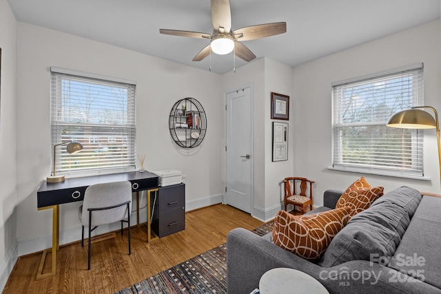 office space with ceiling fan, baseboards, and wood finished floors