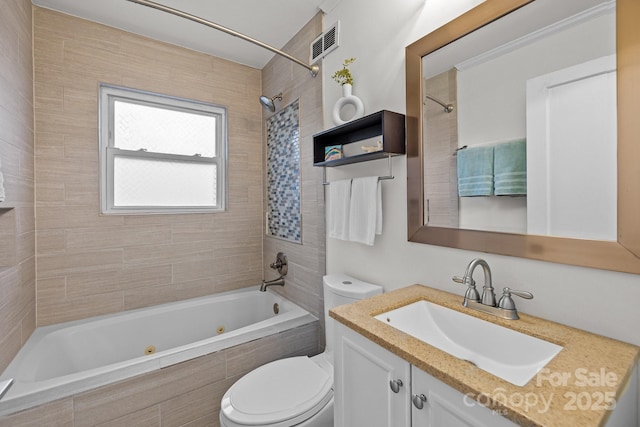 bathroom featuring visible vents, toilet, vanity, and a combined bath / shower with jetted tub