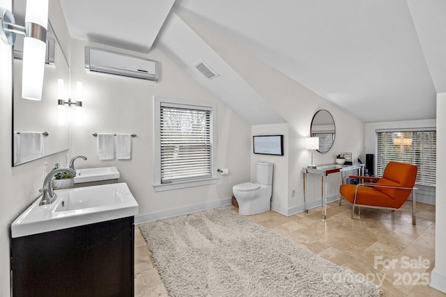 bathroom with visible vents, baseboards, an AC wall unit, lofted ceiling, and a sink