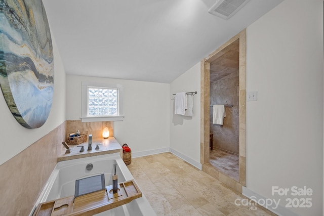 home office with visible vents, baseboards, and vaulted ceiling