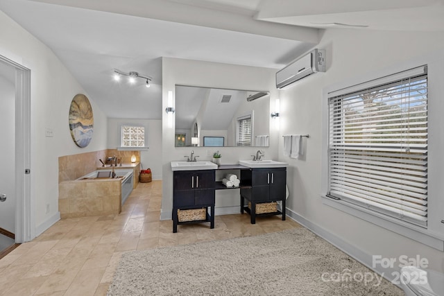 full bathroom with vaulted ceiling, an AC wall unit, and a sink