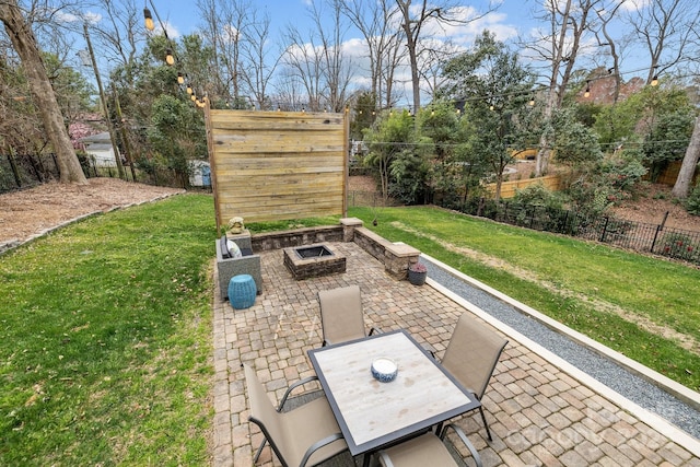 view of patio with outdoor dining area, a fire pit, and a fenced backyard