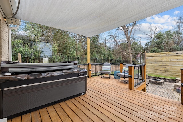 deck featuring a fire pit and a fenced backyard