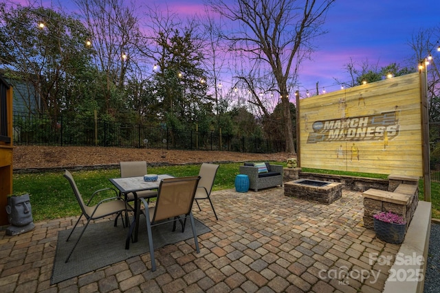 view of patio with outdoor dining area, fence, and an outdoor fire pit