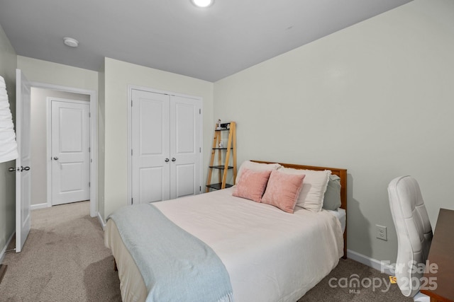 bedroom featuring a closet, baseboards, and carpet