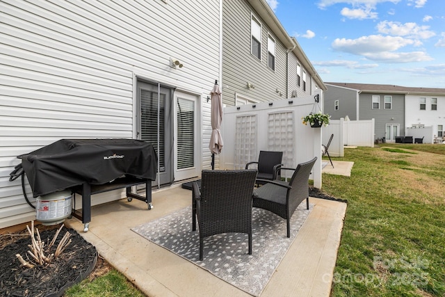 view of patio / terrace with area for grilling and fence