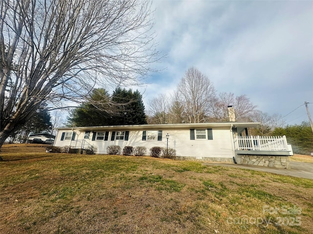 single story home with a front lawn and a chimney