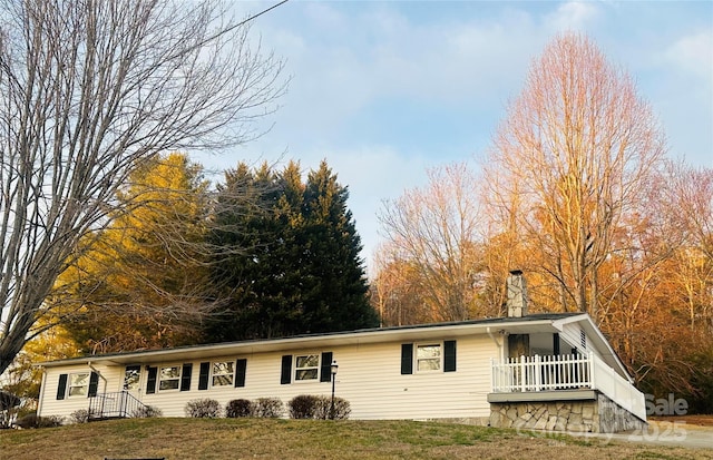 single story home with a front lawn and a chimney