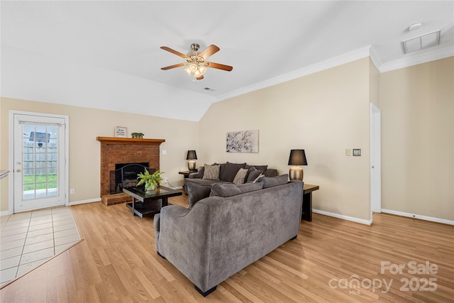 living room featuring visible vents, baseboards, light wood-type flooring, vaulted ceiling, and a ceiling fan